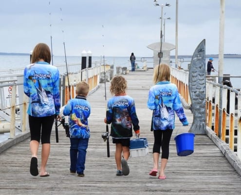 kids walking down a jetty