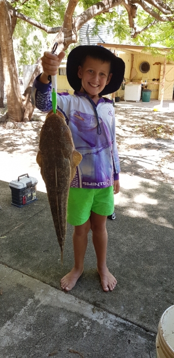 Tackle World's Local Hero Ryley Siandri. Ryley is holding the rewards for his hard work, a nice big flathead.