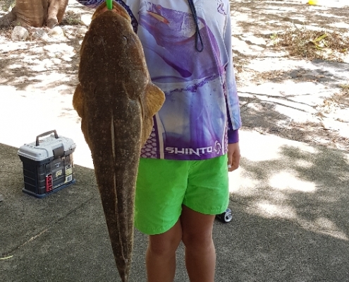 Tackle World's Local Hero Ryley Siandri. Ryley is holding the rewards for his hard work, a nice big flathead.